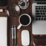 Creative planning workspace with notebook, laptop and coffee